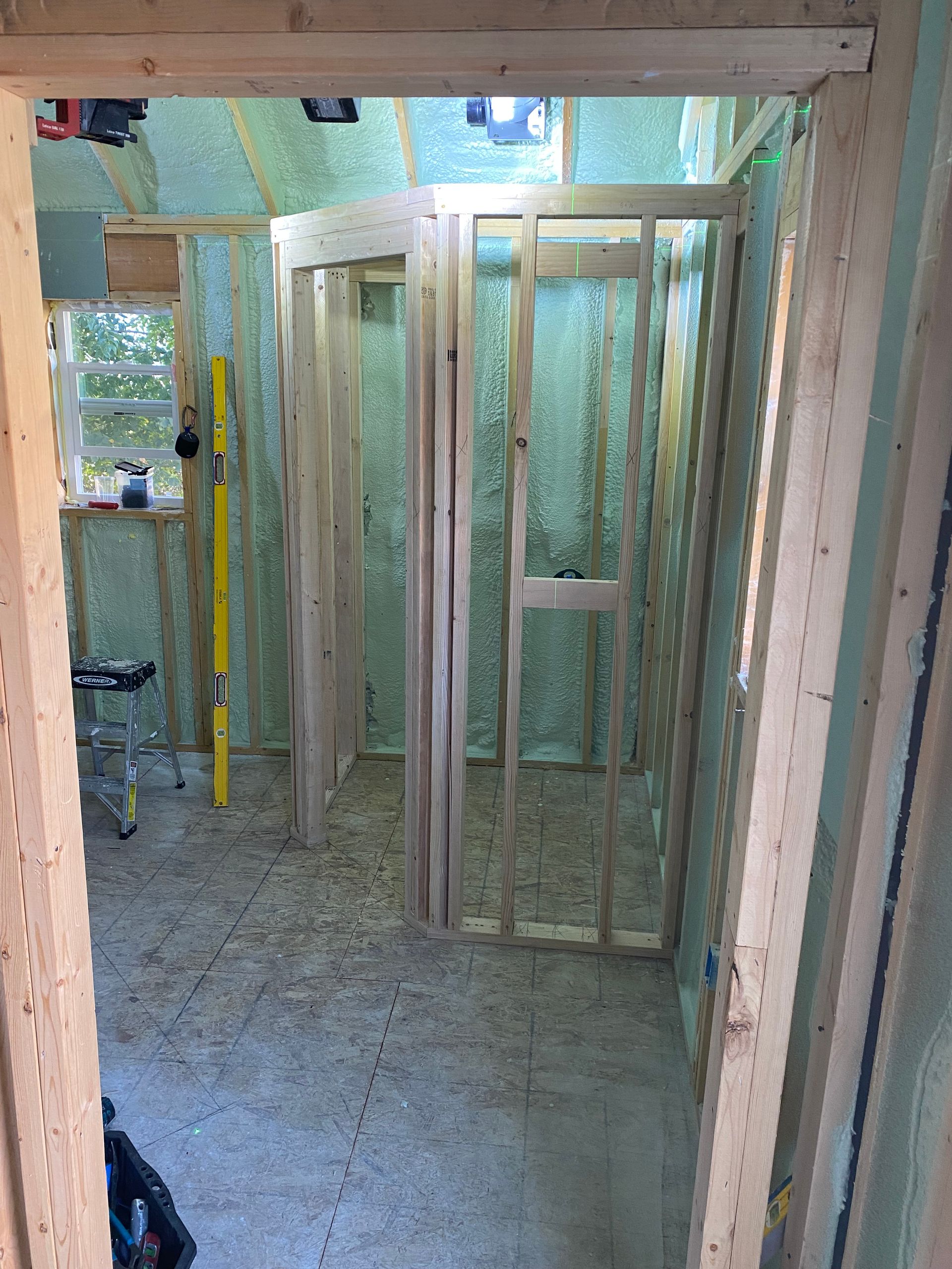 A room is being built with wooden frames and insulation.