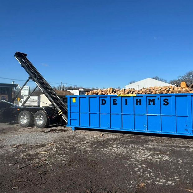 A row of garbage trucks from Deihm's Disposal of PA