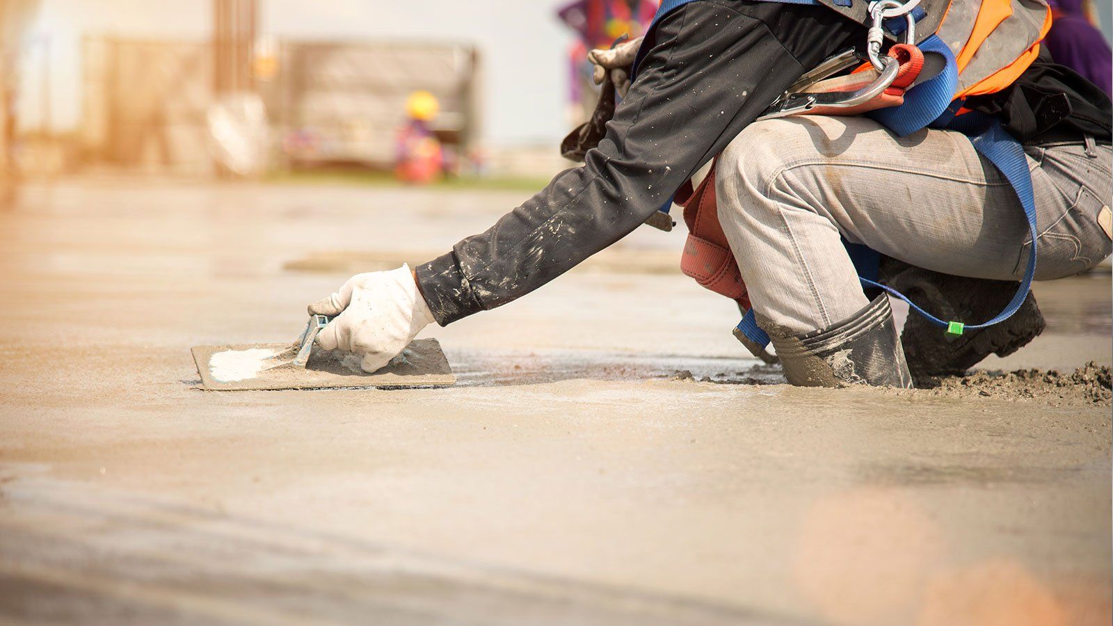 Worker applying concrete to a foundation