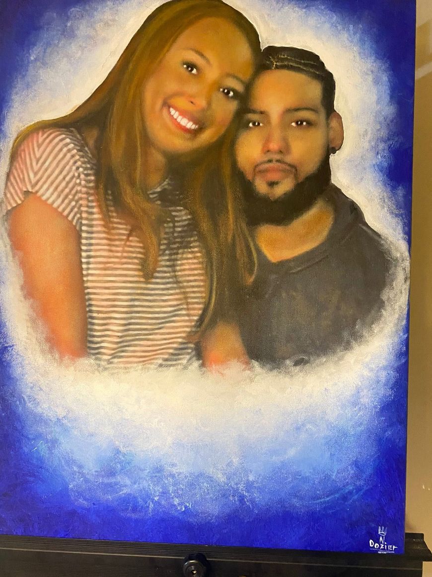 Smiling couple portrait on a blue background, with a soft white glow around them