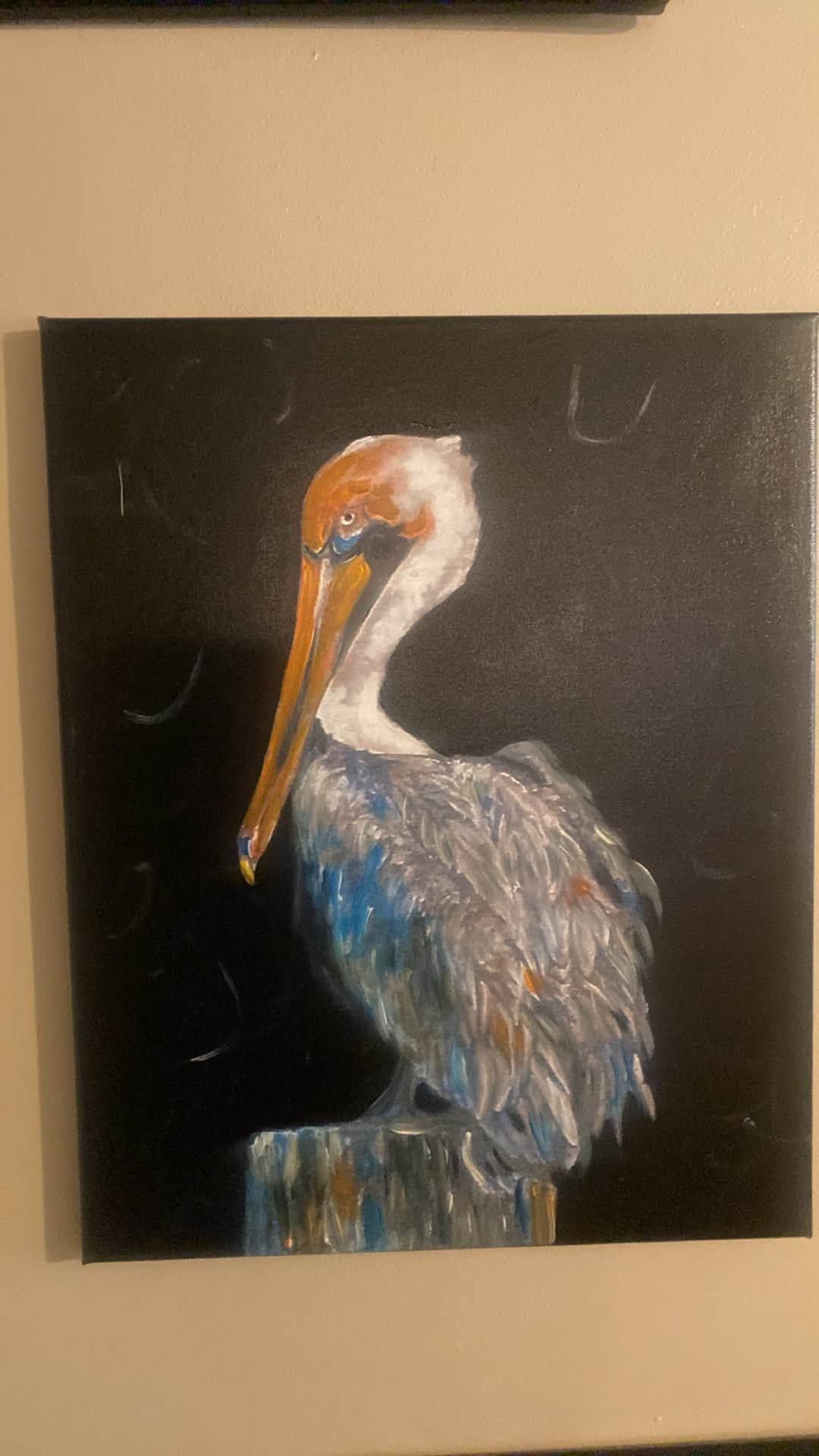 Painting of a pelican with a white head, orange beak, and gray-blue body on a black background