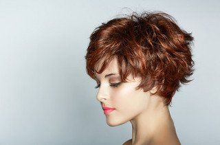 A lady with a short brown pixie cut with red lowlights