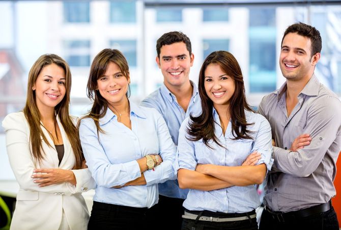 a group of business people are posing for a picture in an office .