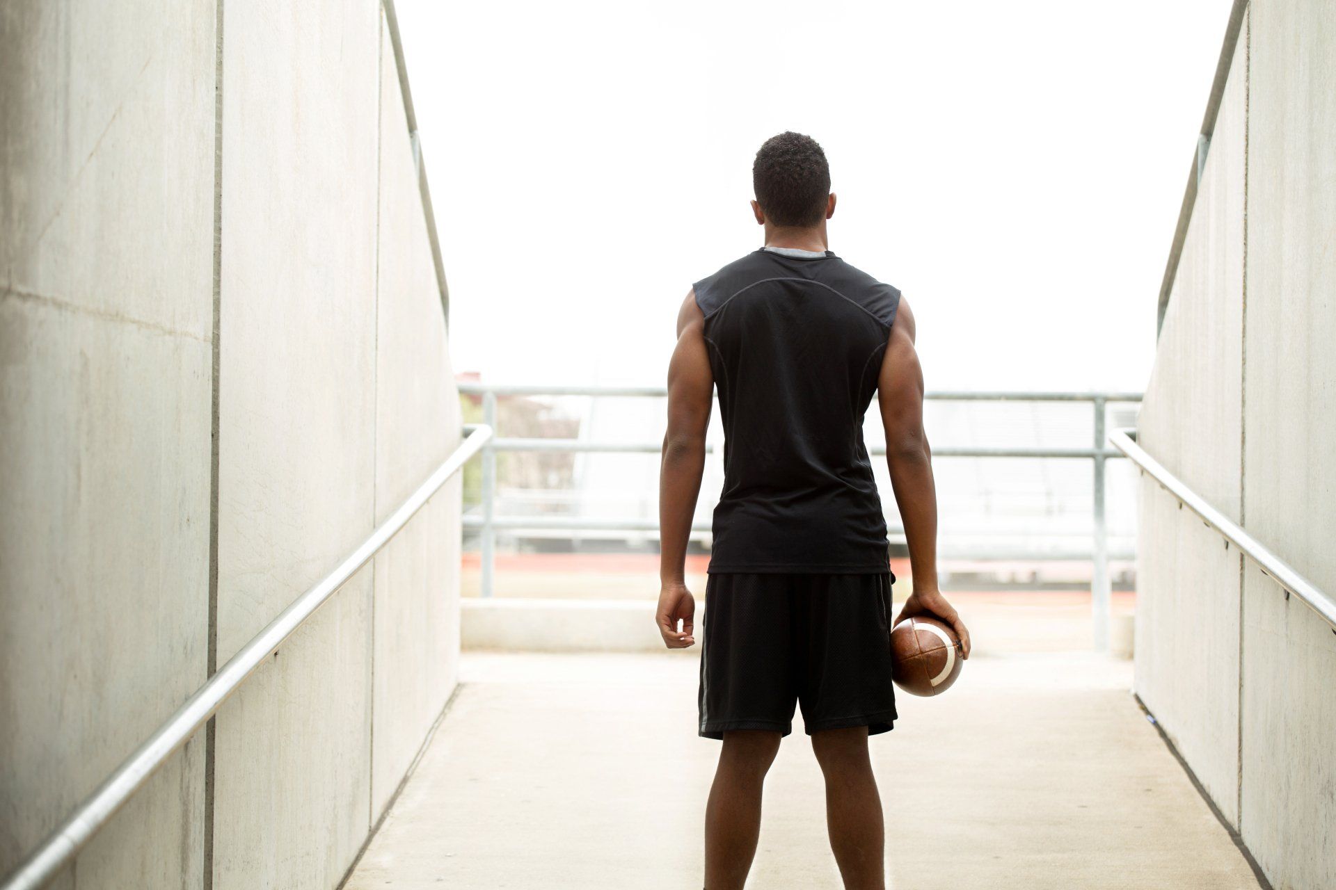 Training Day. American football athlete heading out on the field for training.