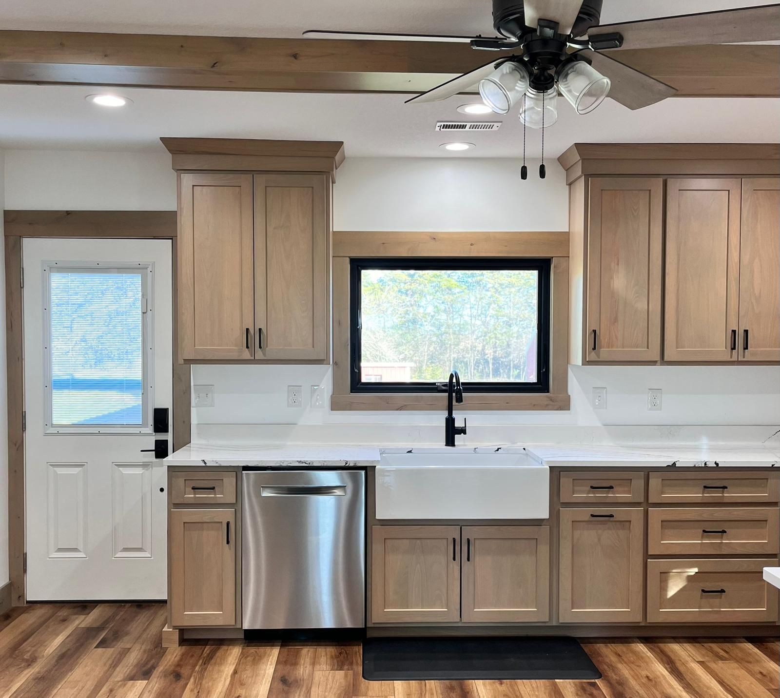Kitchen with light wood cabinets, stainless steel appliances, and a white countertop.