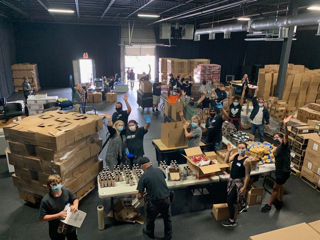 A group of people are working in a large warehouse.