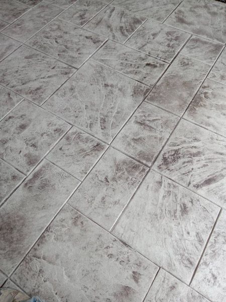 Gray marbled floor tiles laid in a diagonal pattern, viewed from above