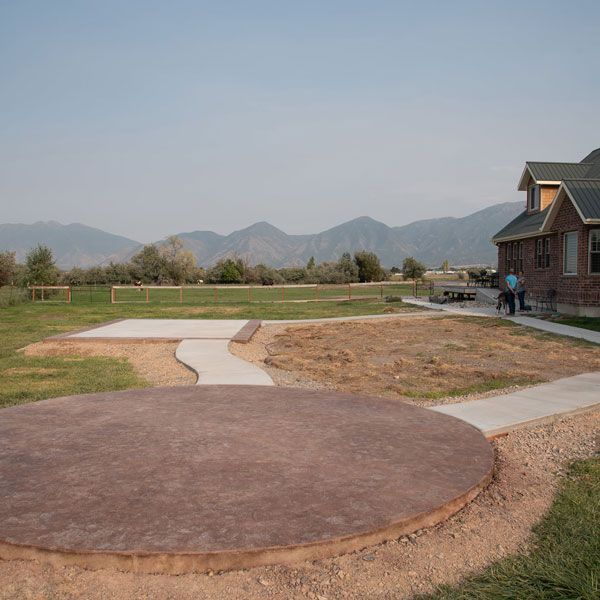 Backyard patio and lawn with mountain view beside a house