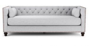 Elegant gray tufted sofa with two side cushions, featuring decorative nailhead trim and dark wooden legs.