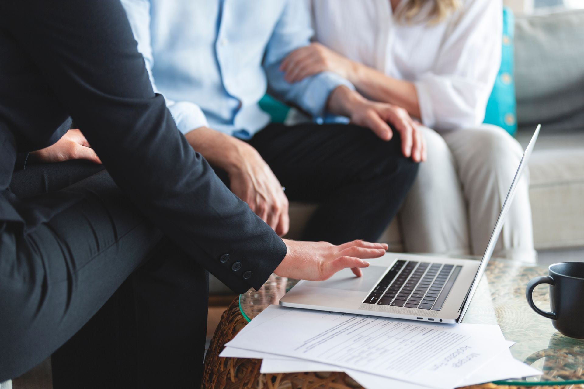 Financial advisor showing information on a laptop to a senior couple.