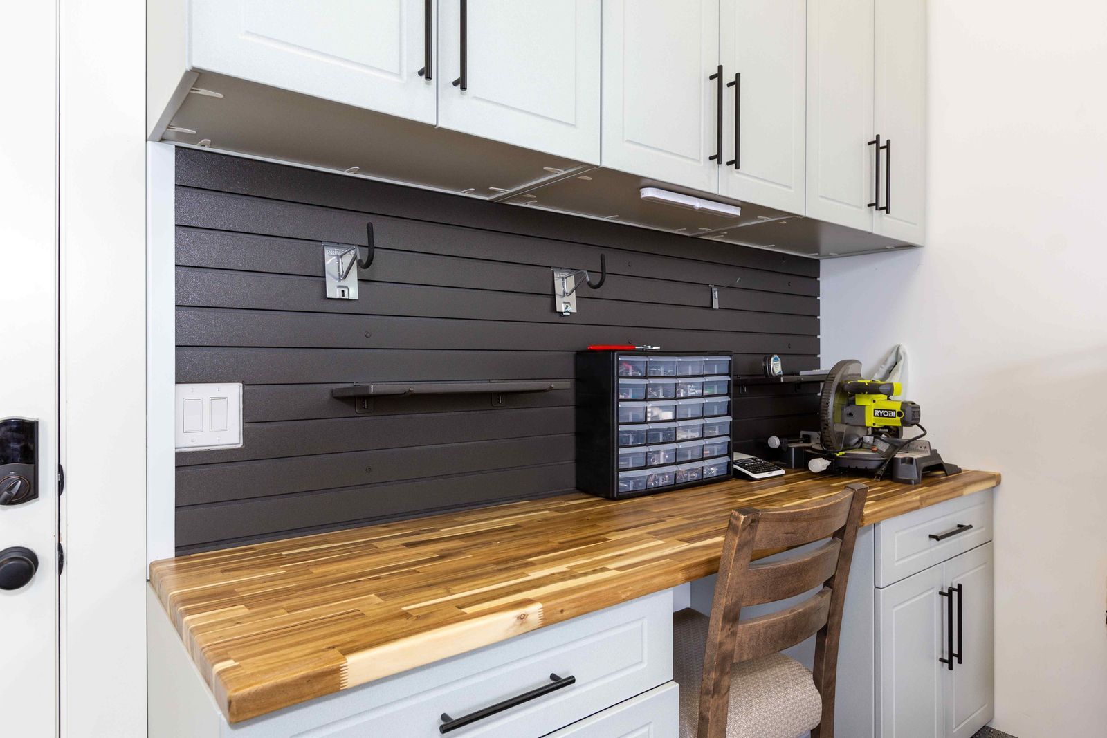 A kitchen with a wooden counter top and a wooden chair.