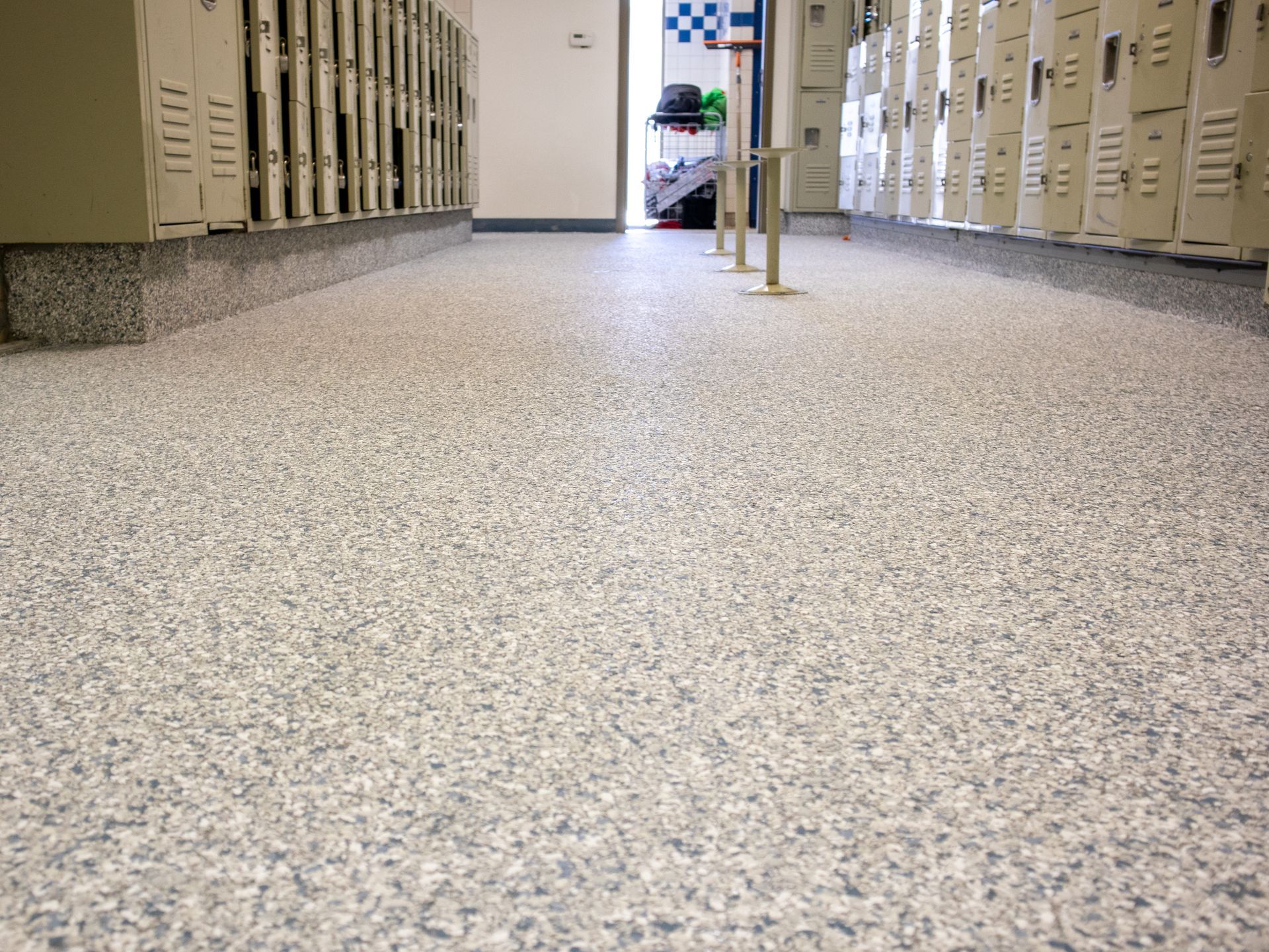 A row of lockers are lined up in a hallway.