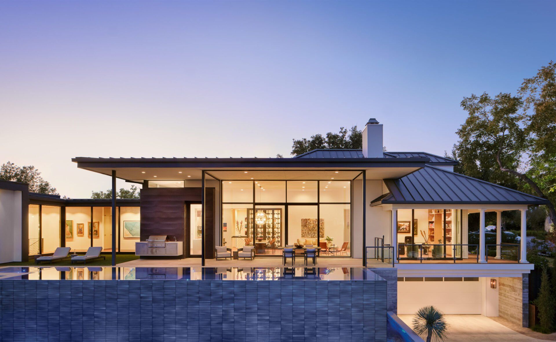 A large house with a swimming pool in front of it