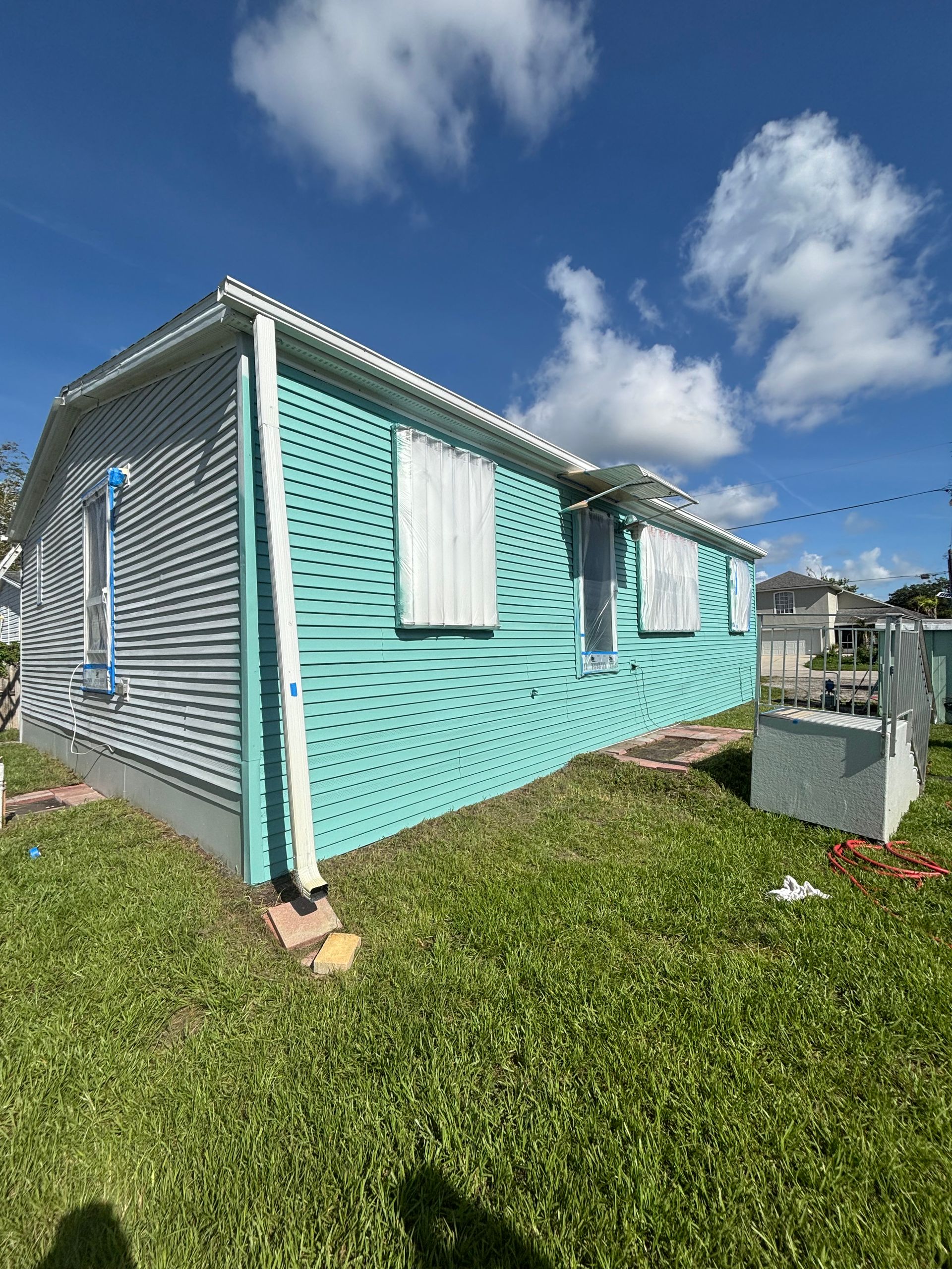 Vinyl siding house painting services in New Smyrna Beach, FL by Atlantic Finish
