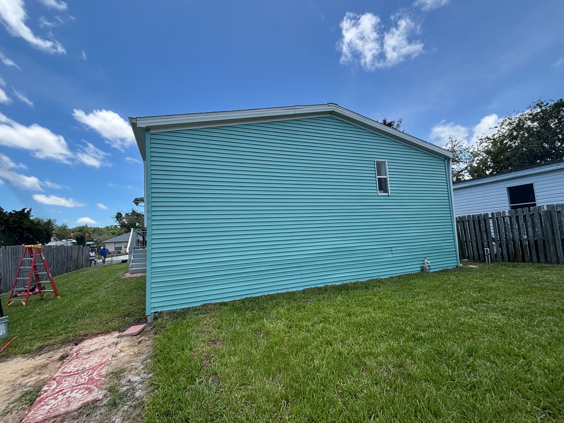 Homeowner's vinyl siding house transformed with premium exterior paint in Edgewater, FL