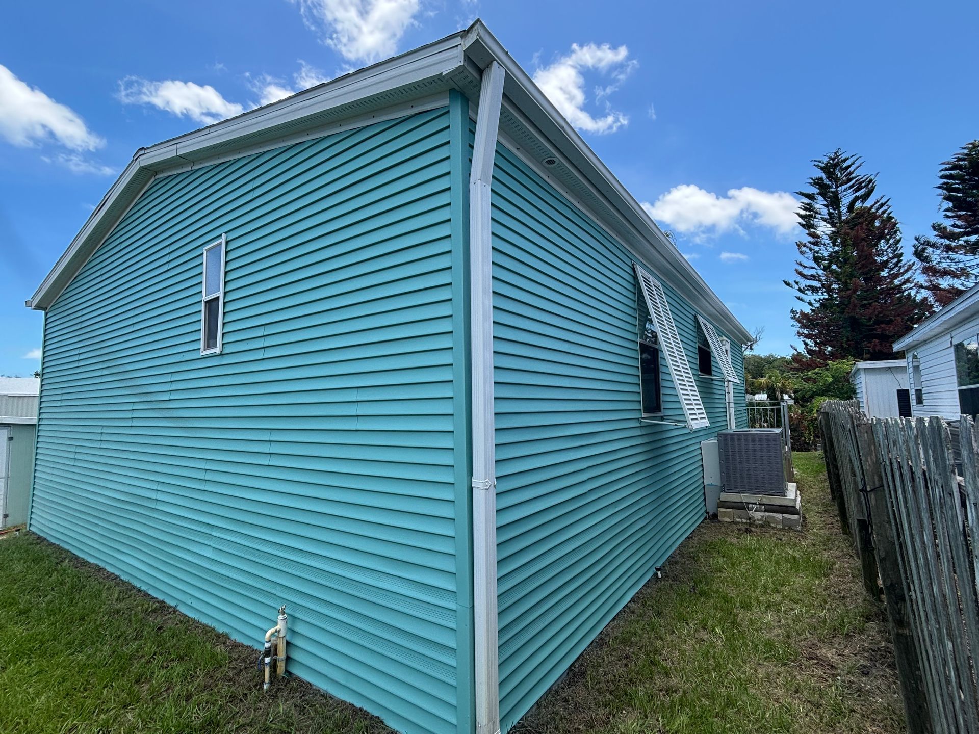 Freshly painted vinyl siding exterior featuring Sherwin-Williams Emerald VinylSafe colors in Edgewater