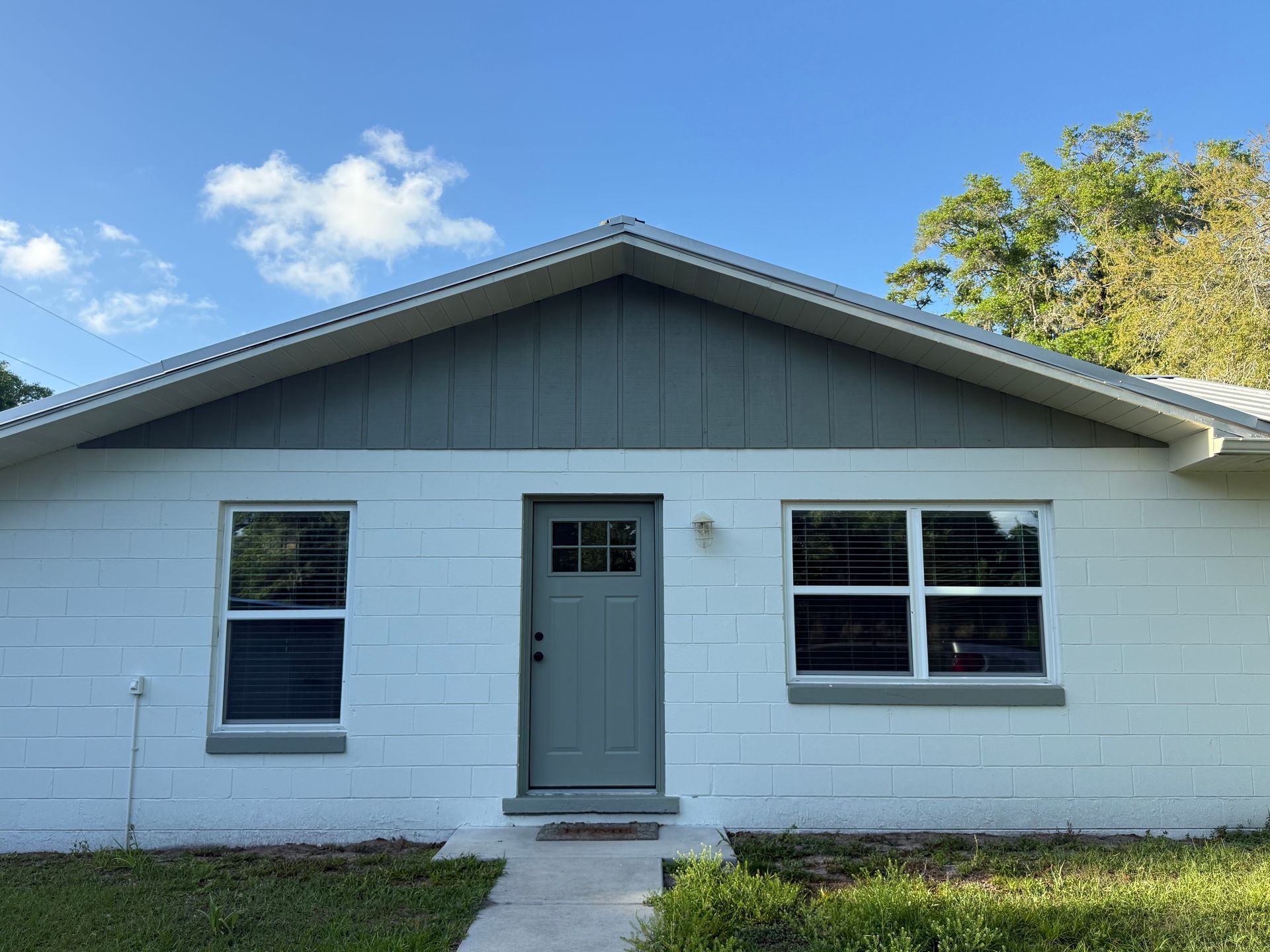 Exterior transformation of a CMU block home in DeLand, Florida completed by Atlantic Finish, helping improve curb appeal and prepare the property for a successful sale.
