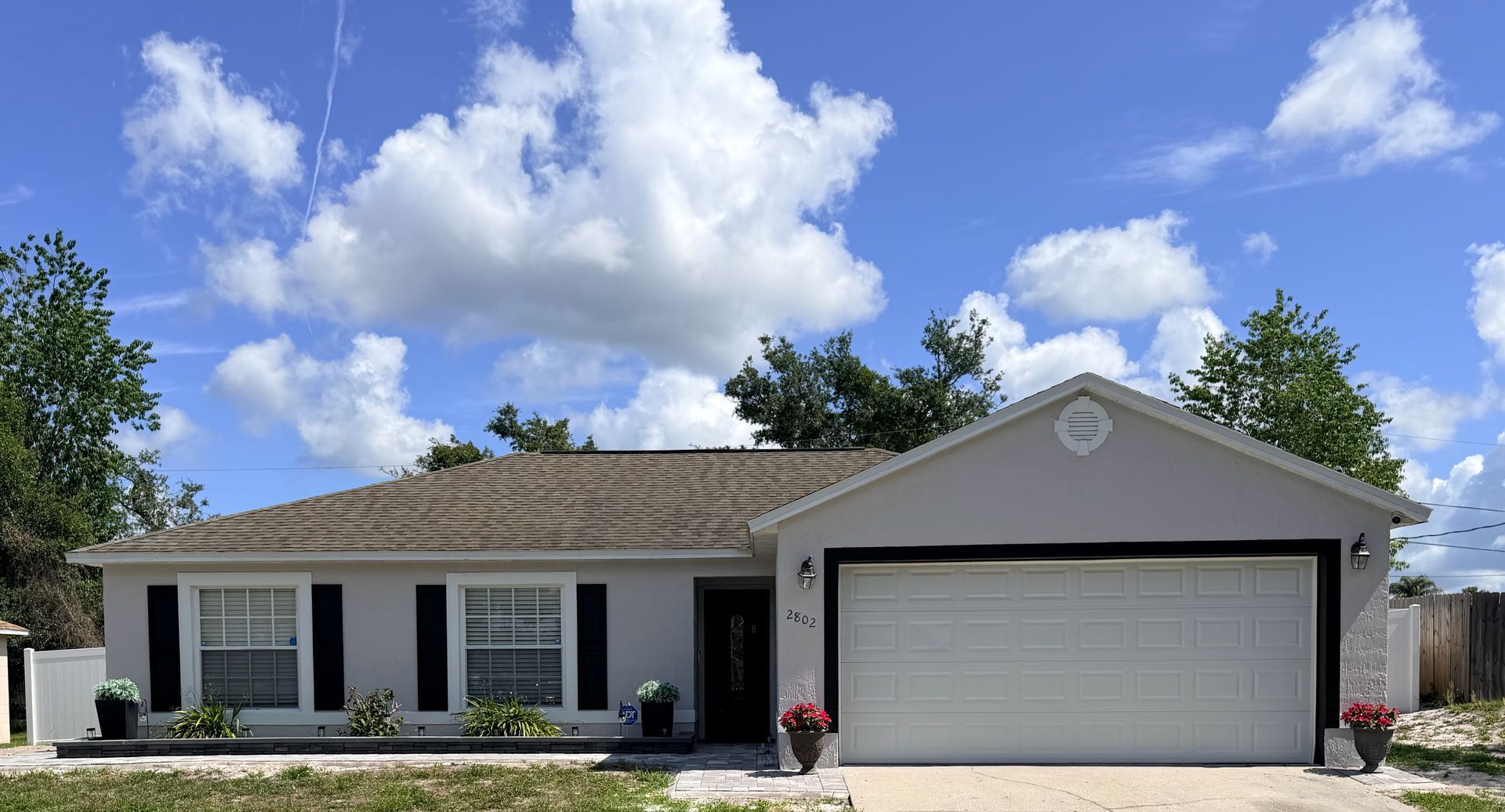 Exterior repaint of a stucco and block home in Deltona, Florida completed by Atlantic Finish featuring extensive surface preparation, crack sealing, and a professional two-coat paint system.