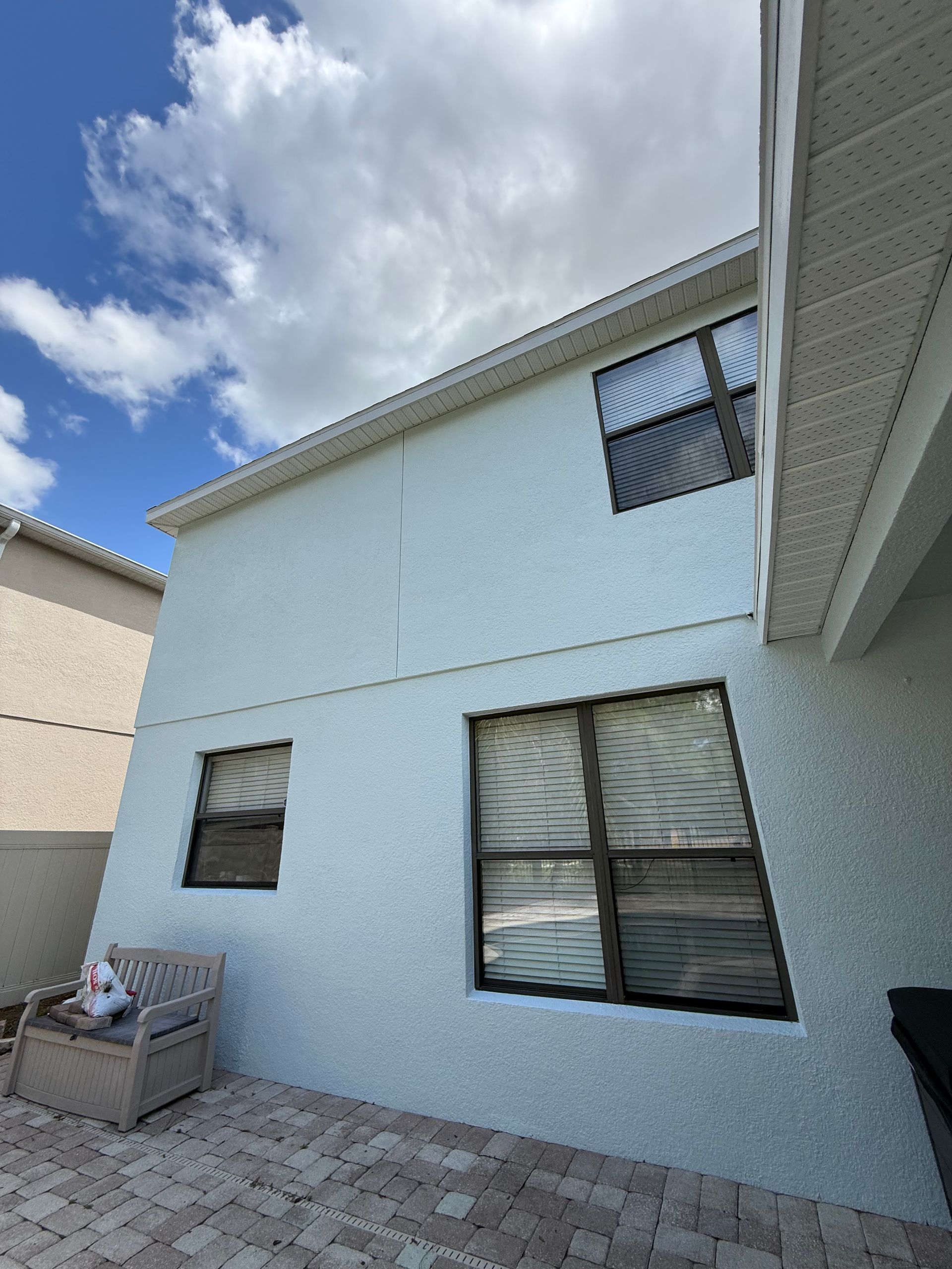 Freshly primed soffits ready for exterior painting on a stucco house in DeLand