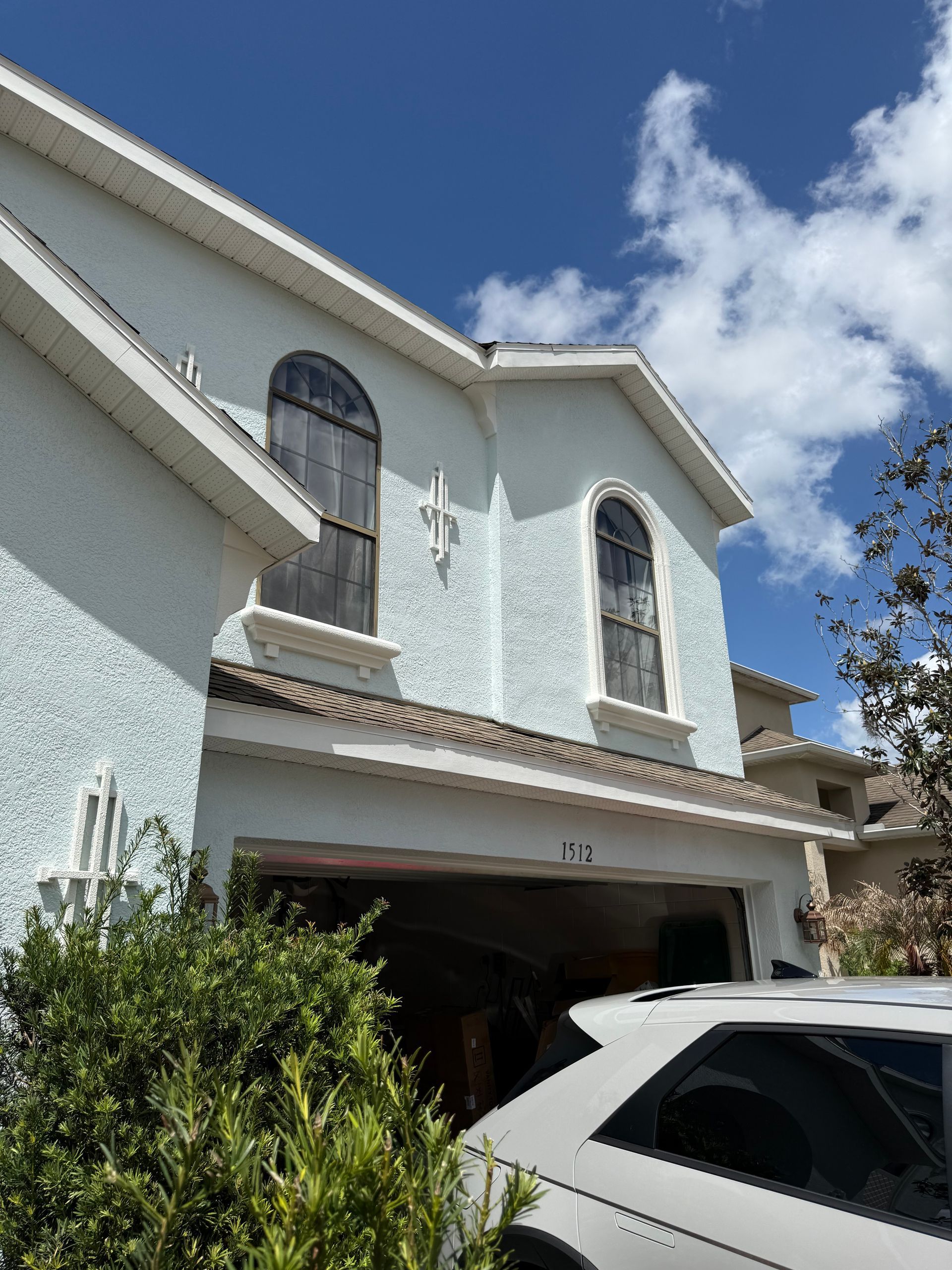 Applying two coats of Sherwin-Williams Duration paint to a two-story home in DeLand