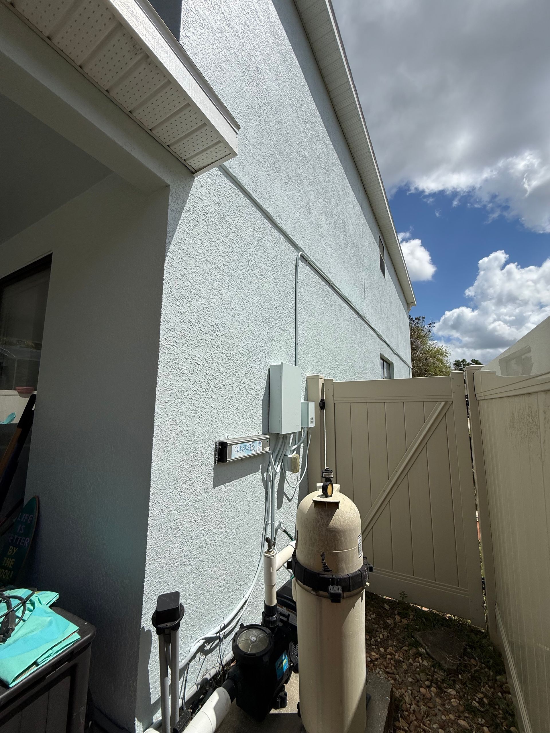 Professional spray application of Sherwin-Williams Duration paint on stucco exterior in DeLand
