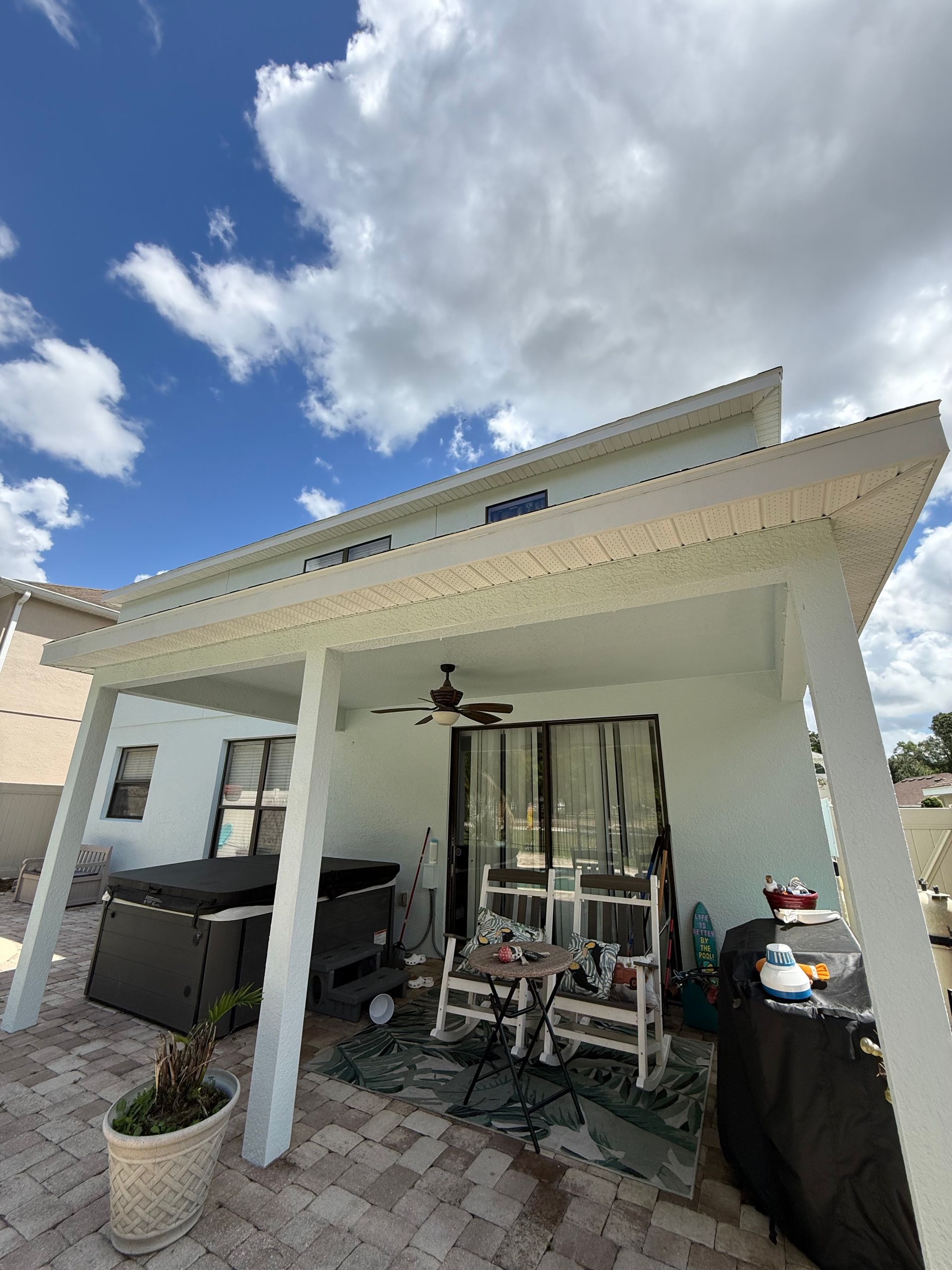 Rear elevation of freshly painted stucco home with premium Sherwin-Williams coatings