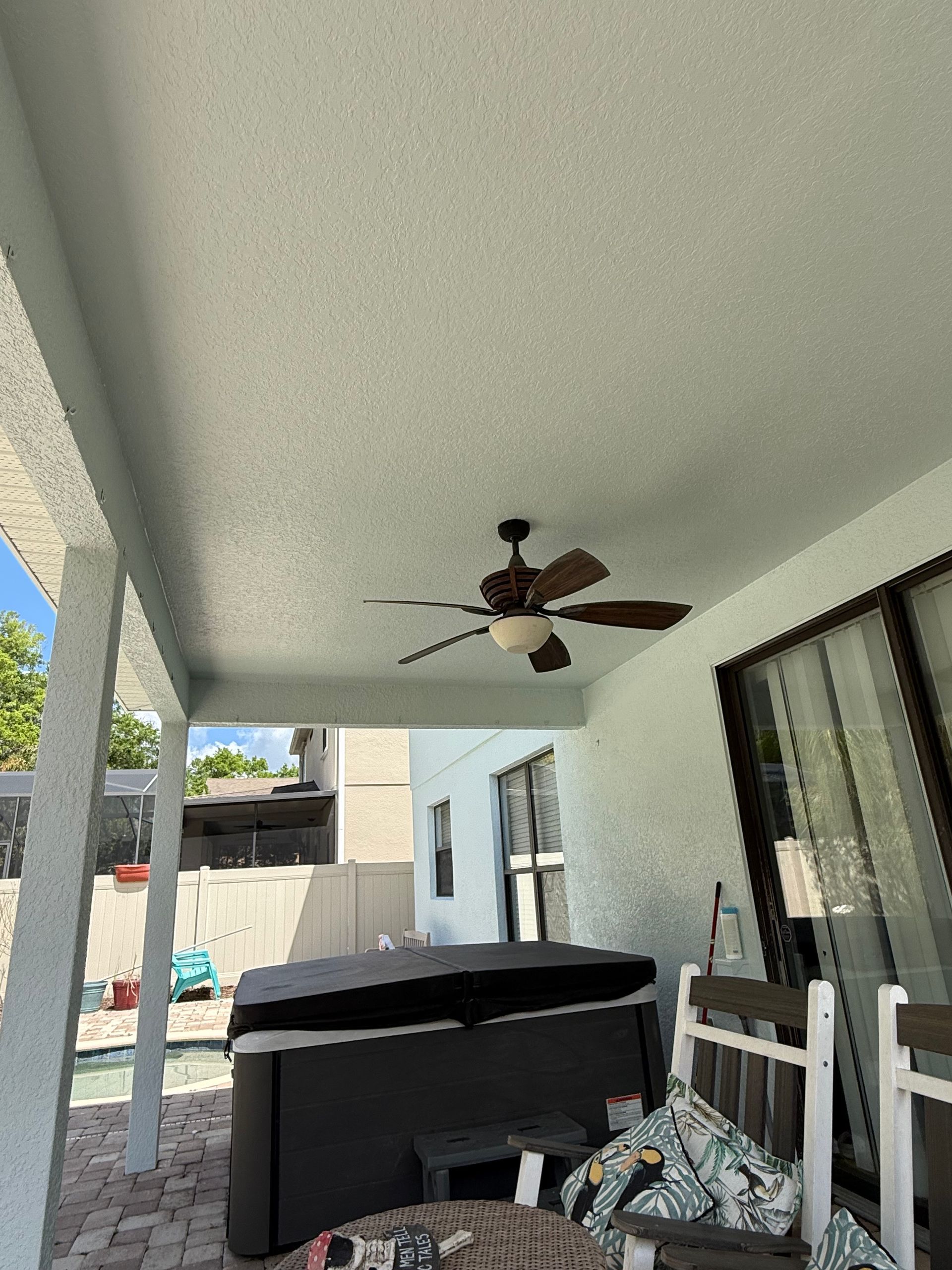 Carefully painting a covered back porch ceiling while protecting the homeowner's hot tub and outdoor furnishings in DeLand, FL