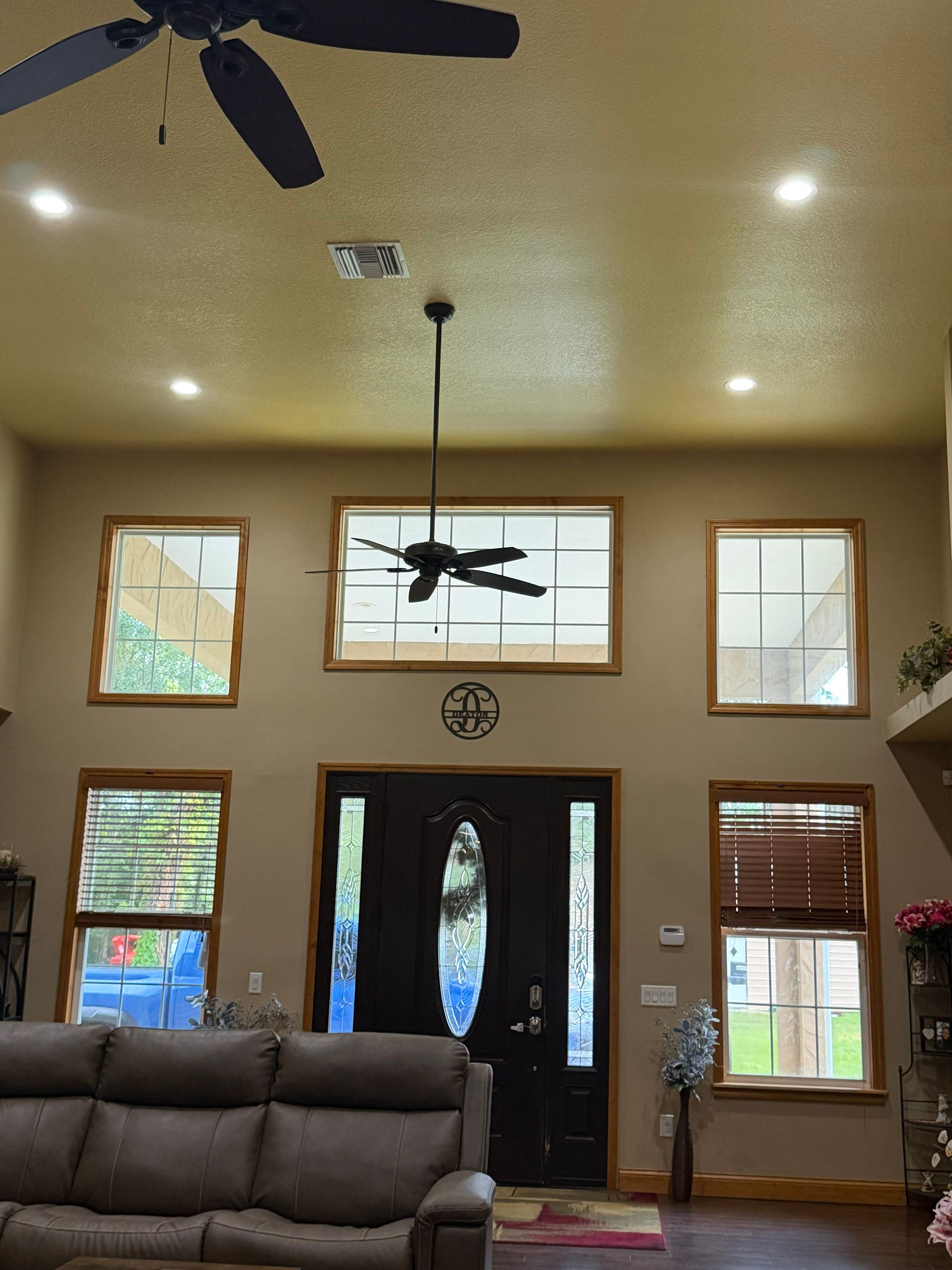 before painting in living room with high ceilings