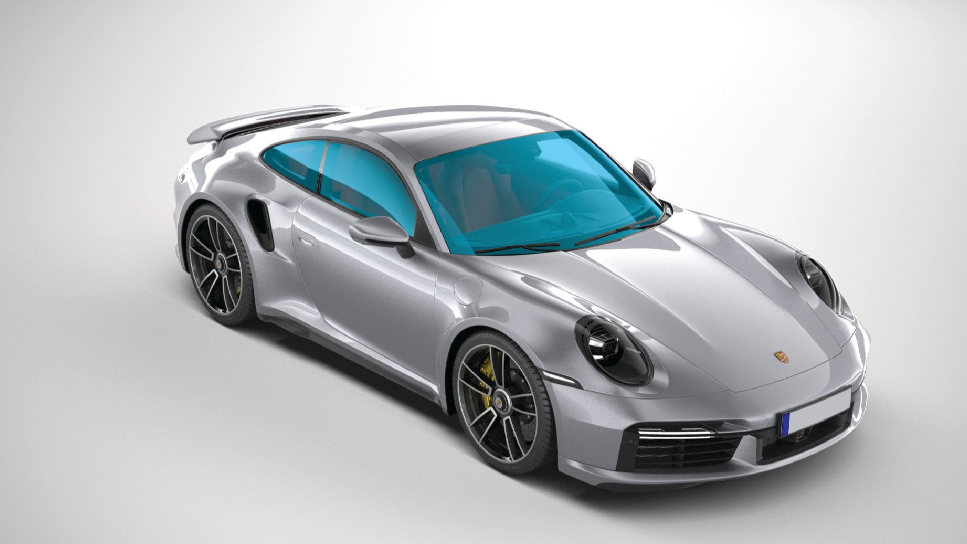 Silver sports car with blue-tinted windows on a white background showing total car windshield coating coverage