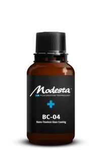 Amber bottle of Modesta BC-04 nano titanium glass coating with black cap on white background