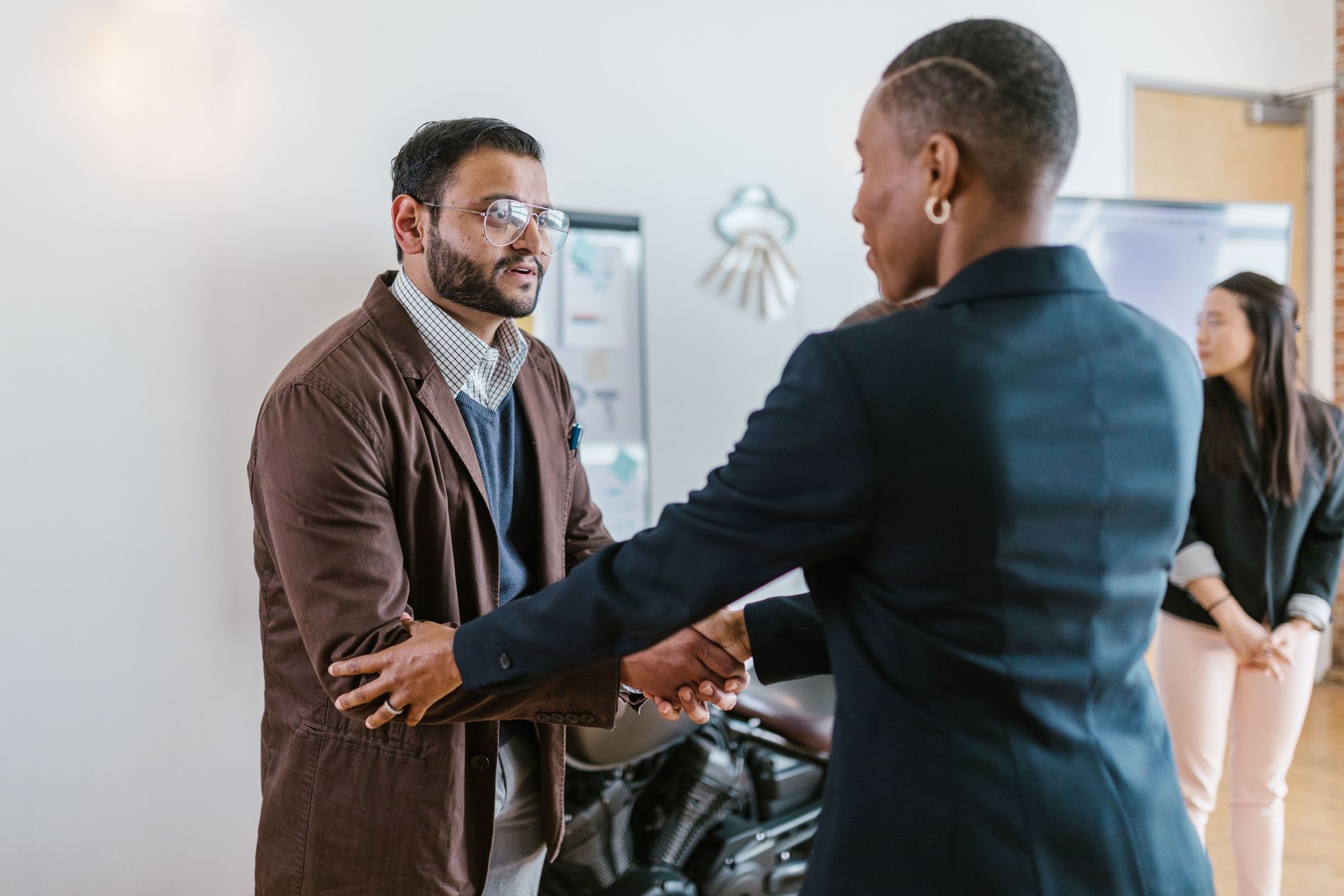 Staff member welcoming a resident at a well-kept home entry