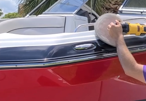 worker with polishing drill shining boat