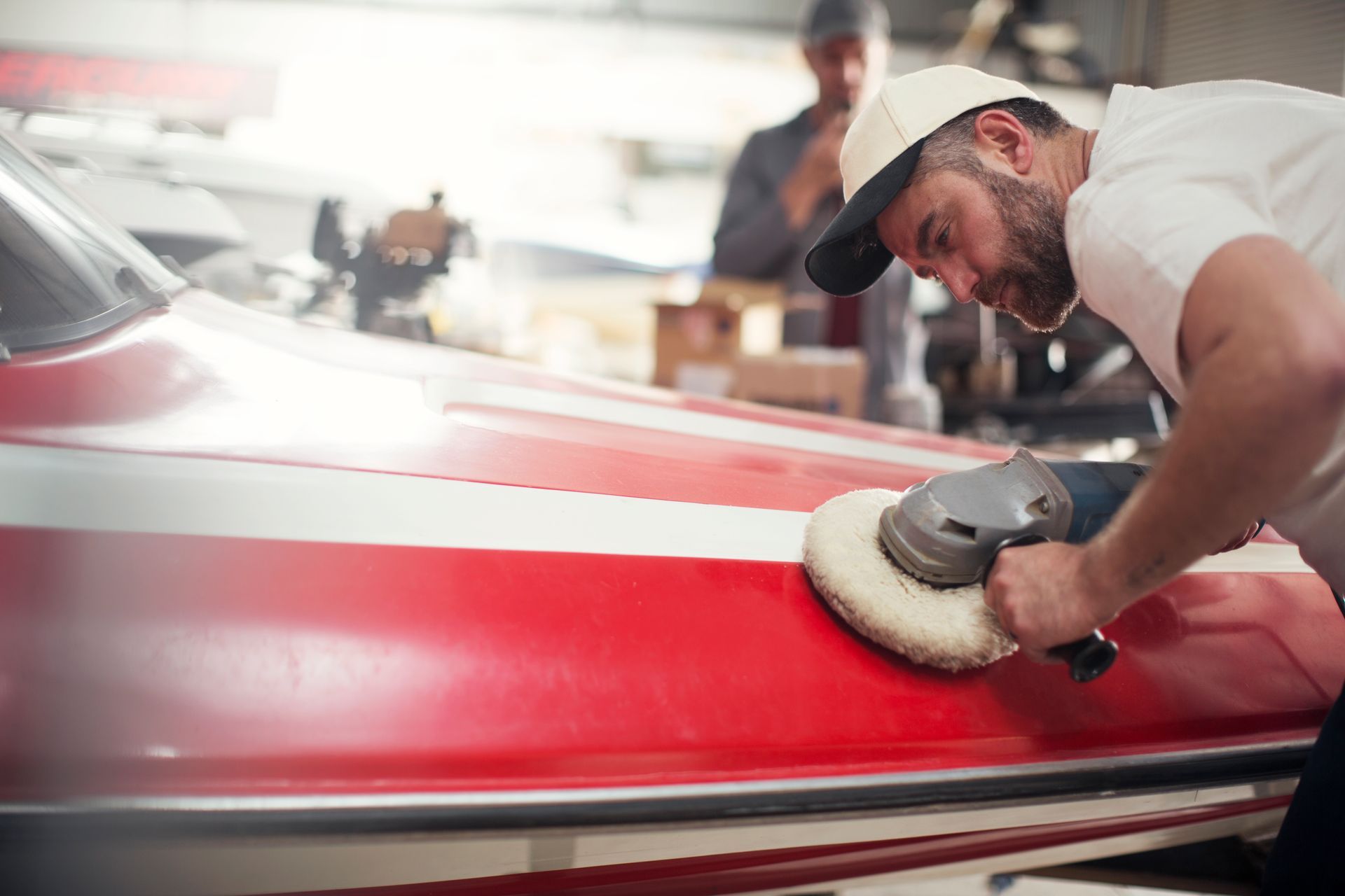operator with drill polishing front of the boat