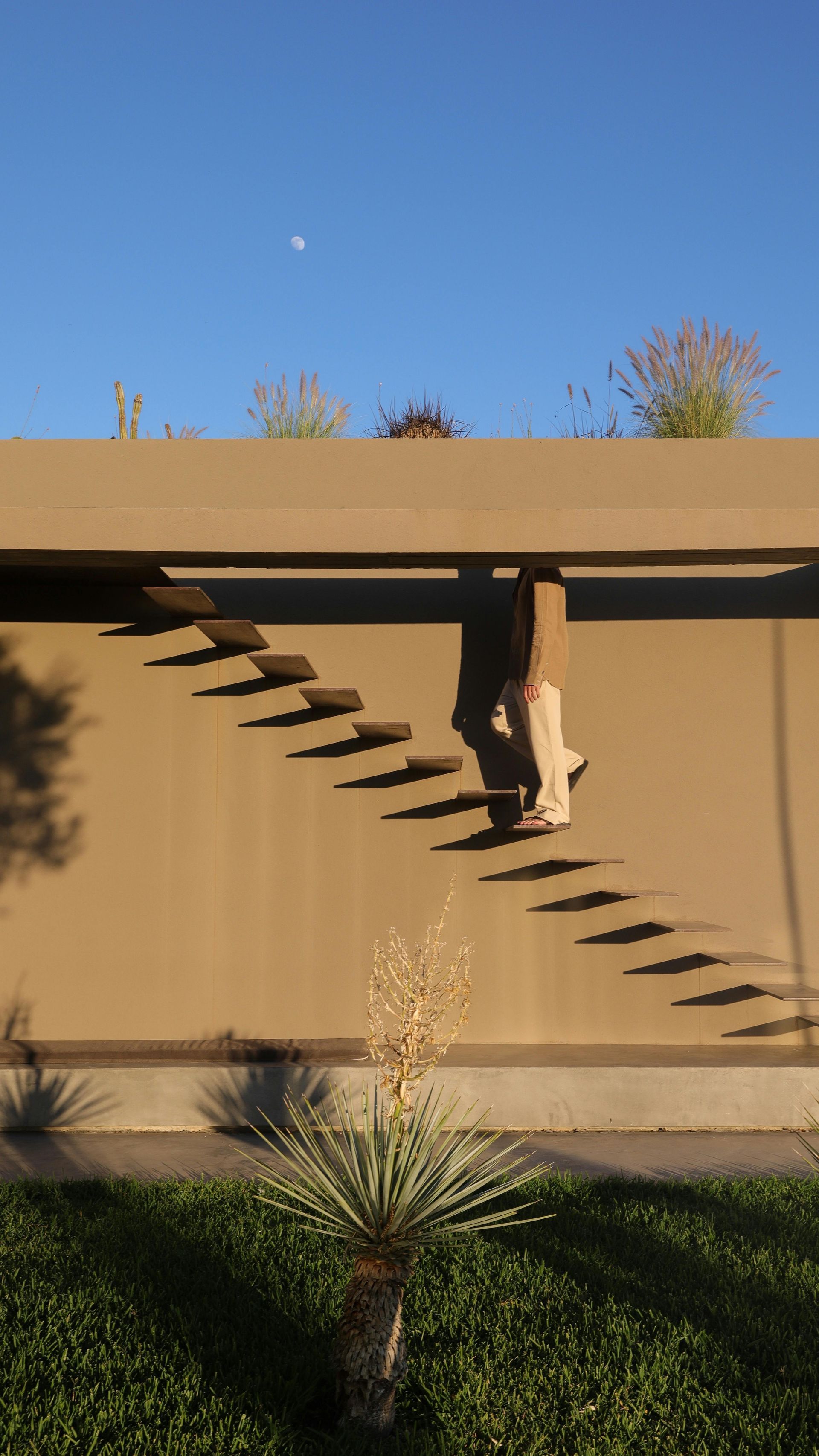 Modern floating staircase with concrete treads cantilevered from exterior wall