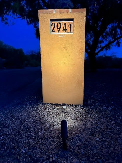 Tall, tan rectangular mailbox with illuminated address