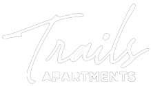 Trails Apartments logo: white script