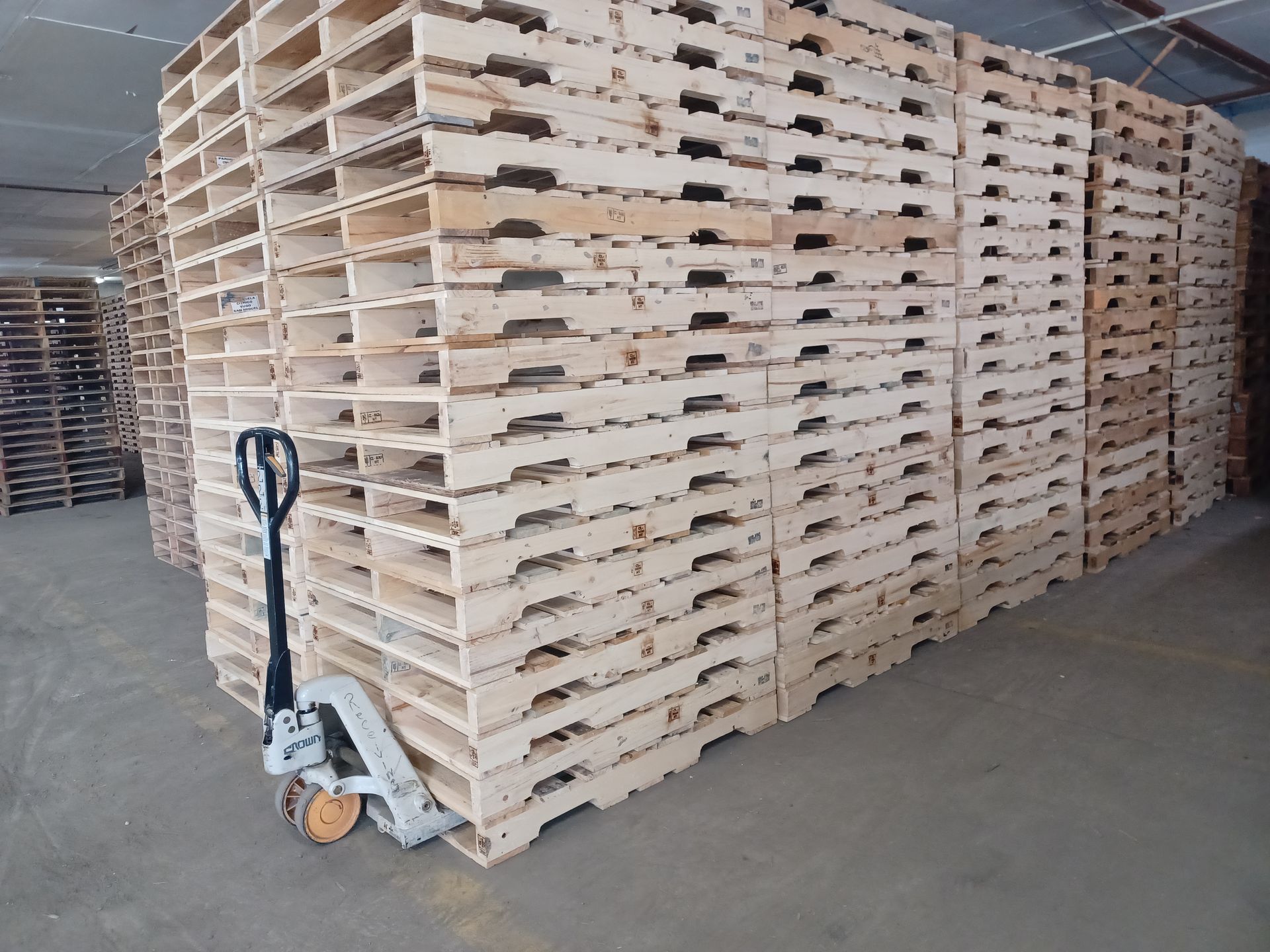 A warehouse filled with lots of wooden pallets