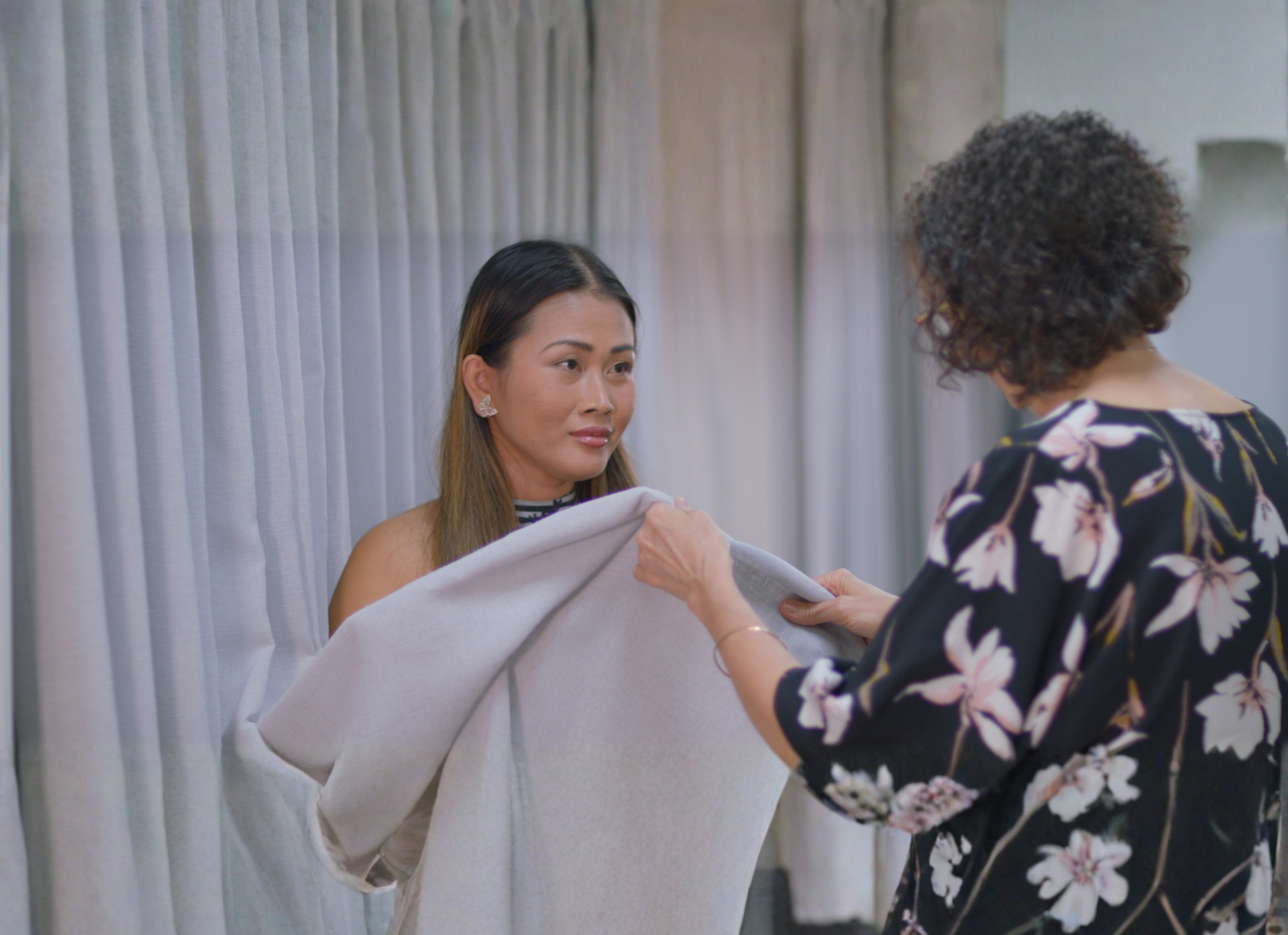 Person Using a Tool to Repair the Upholstery of a Flowered Fabric Seat — Instyle Curtains & Blinds in Bungalow, QLD