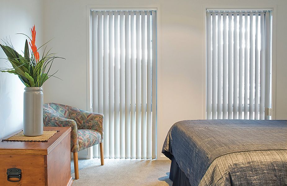Vertical White Blinds on a Window, Partially Blocking Sunlight — Instyle Curtains & Blinds in Bungalow, QLD