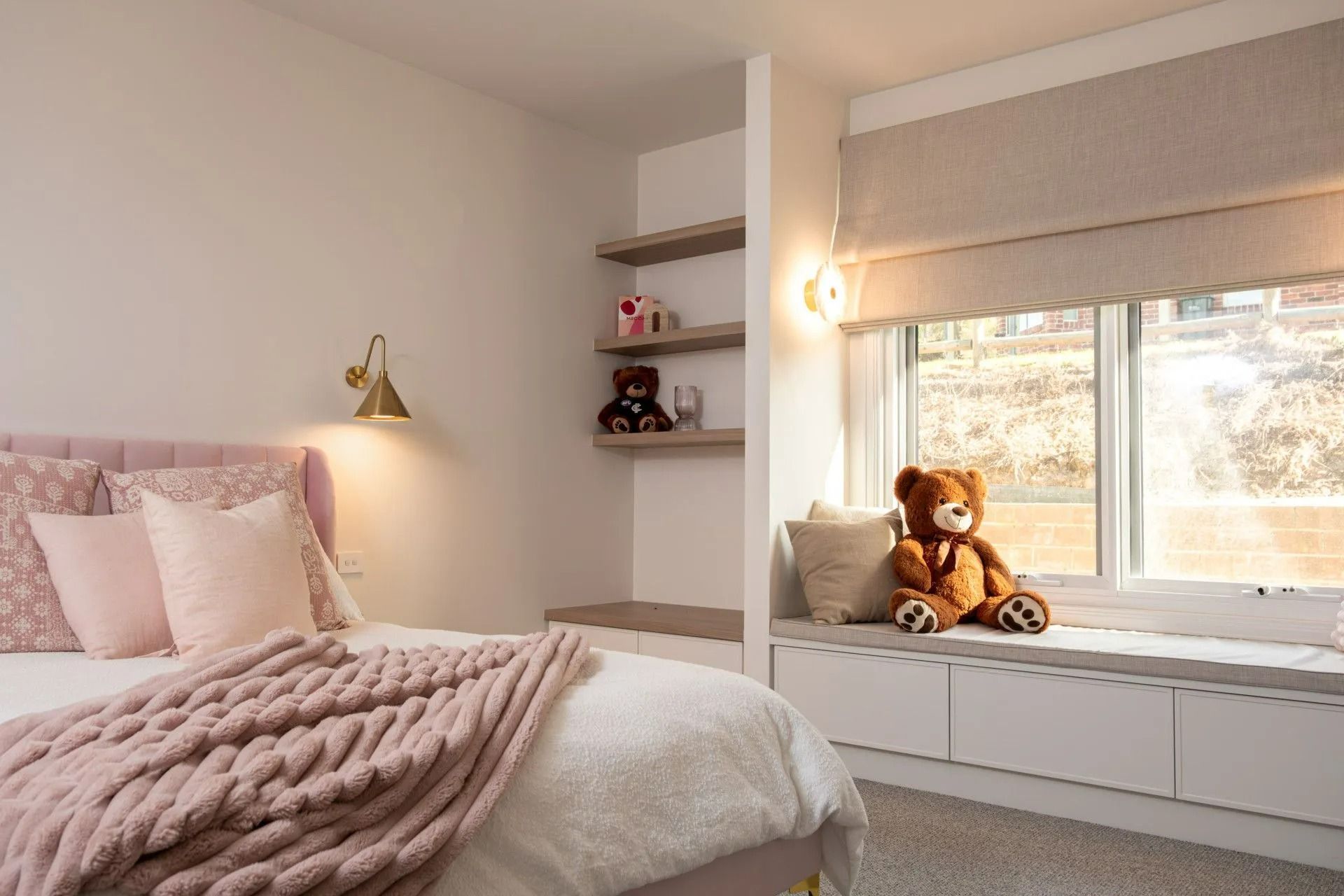 Cozy Bedroom With a Bed, Shelves, and a Window Seat — Instyle Curtains & Blinds in Bungalow, QLD