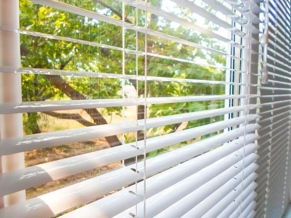 White Venetian Blinds Partially Open — Instyle Curtains & Blinds in Bungalow, QLD