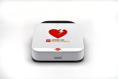 White first-aid kit with red heart and lightning symbol on the lid
