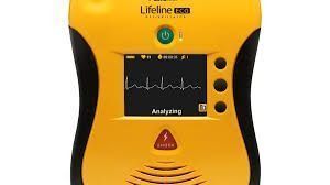 Yellow Lifeline AED defibrillator with screen showing ECG analysis status