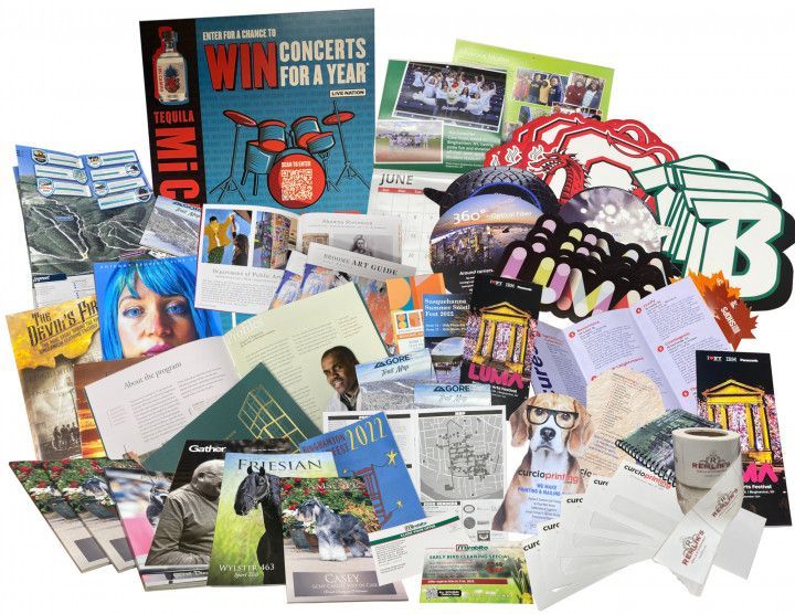 Assorted concert flyers, tickets, and promotional postcards scattered in a colorful pile