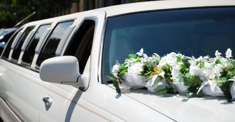 White Limousine Decorated With Flowers and Wedding Rings — Territory Limousine Service in Marrara, NT
