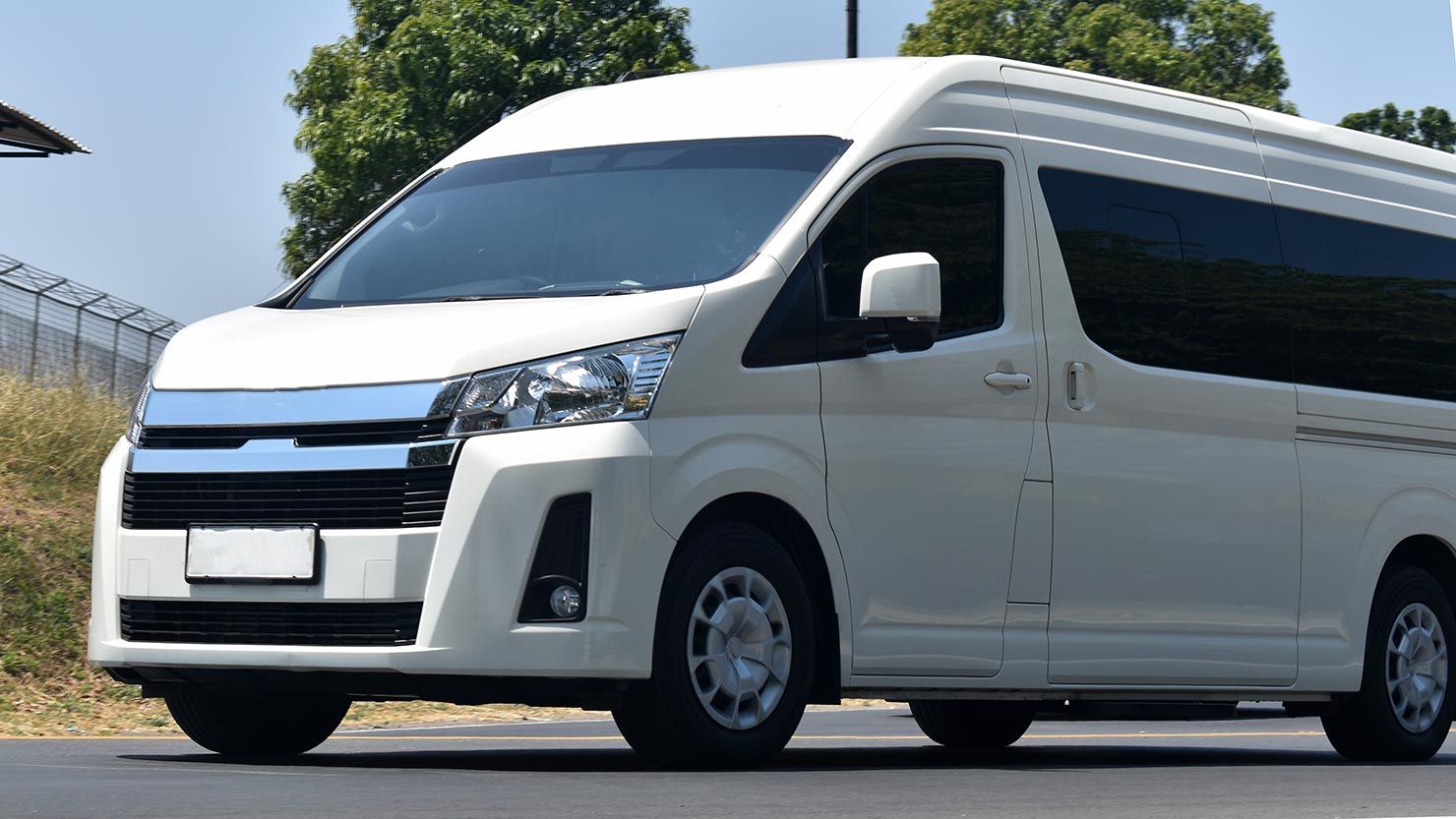 A White Van is Parked on the Side of the Road — Territory Limousine Service in Kakadu, NT