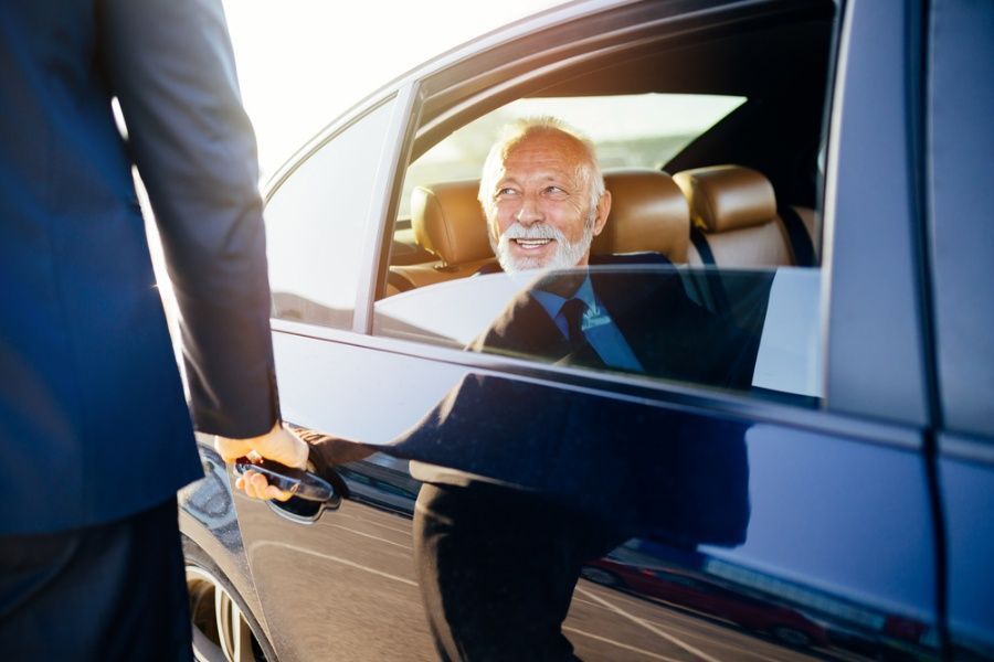 Man in a Suit is Getting Out of a Car — Territory Limousine Service in Marrara, NT