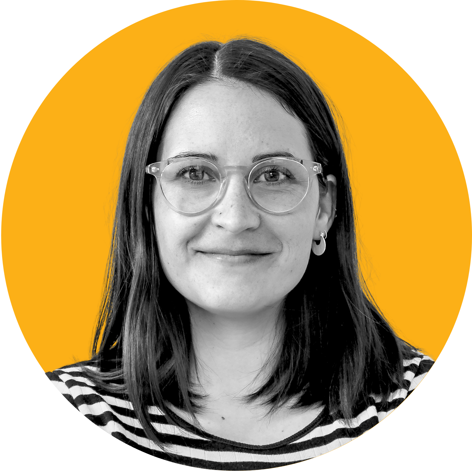 Woman with glasses smiles; black and white portrait, yellow background.