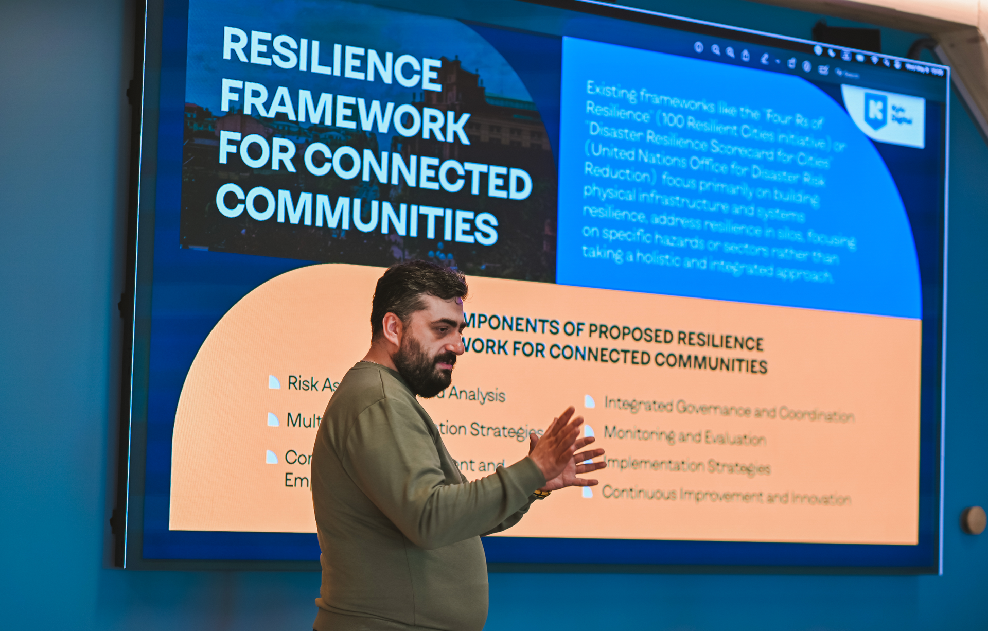 Man presenting to a screen displaying