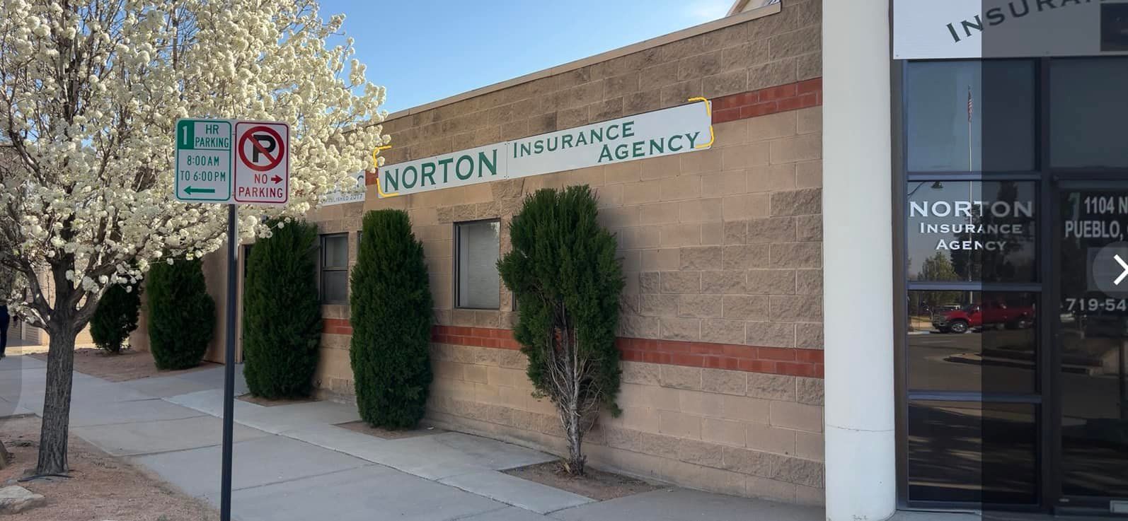 Exterior of the Norton Insurance Agency building. A sign shows 